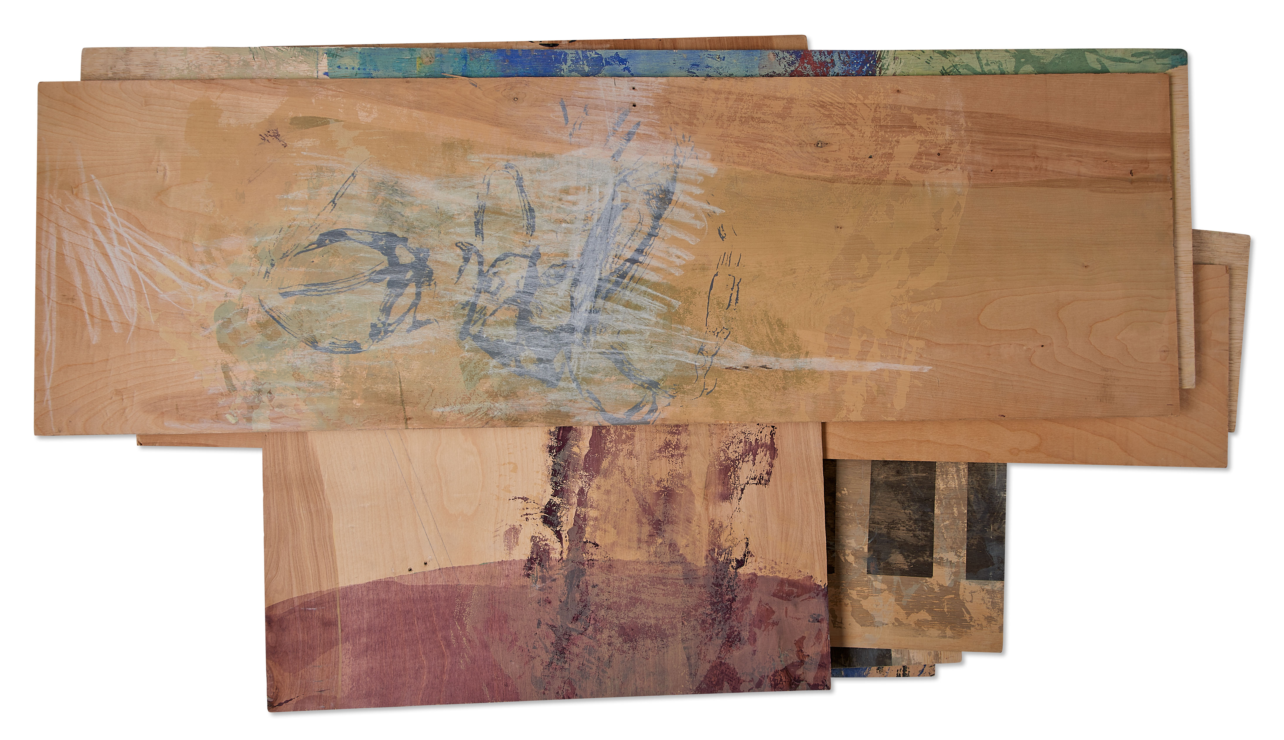 Photograph of stacked pieces of plywood with abstracted printed and drawn imagery in purple, blue, green, black, and white by the artist Caroline Coolidge.