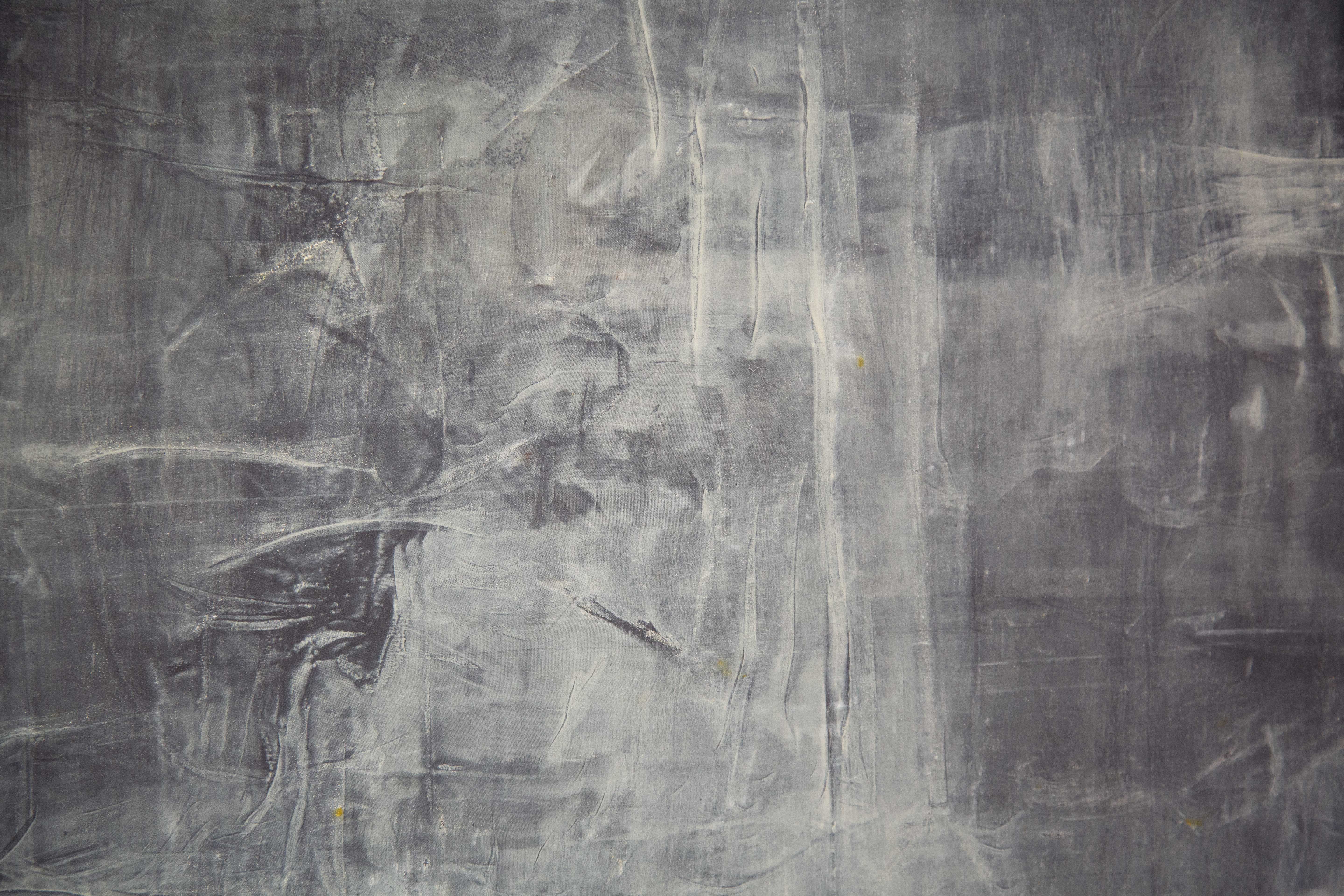 A detail of a grey painting with chalky marks that resemble whirling fog or smoke.